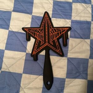 Black Jeffree Star handheld mirror with drips